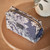 Phytomer branded Navy Travel Pouch with a white stitched seaside print. 