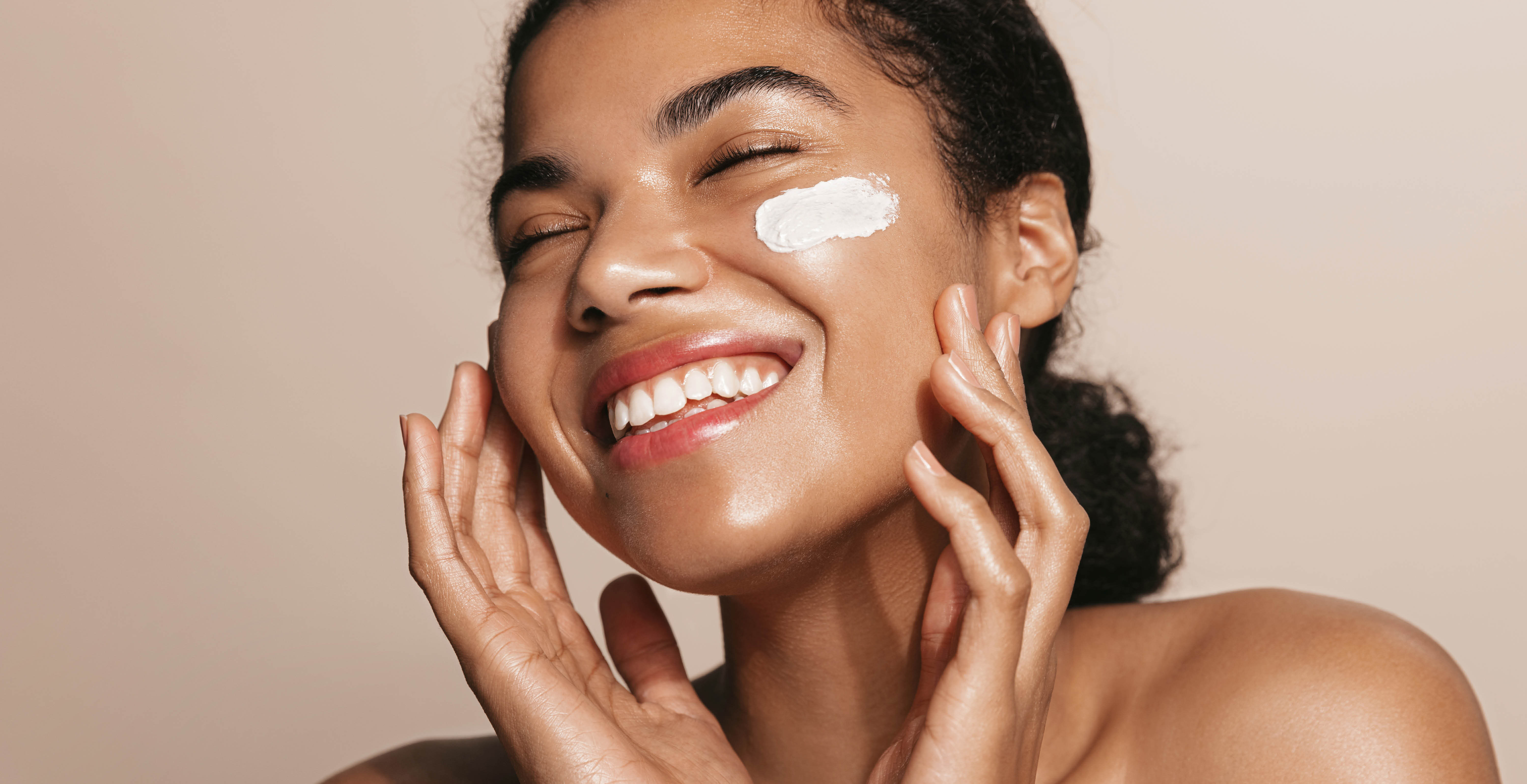 A woman gently caressing her face.