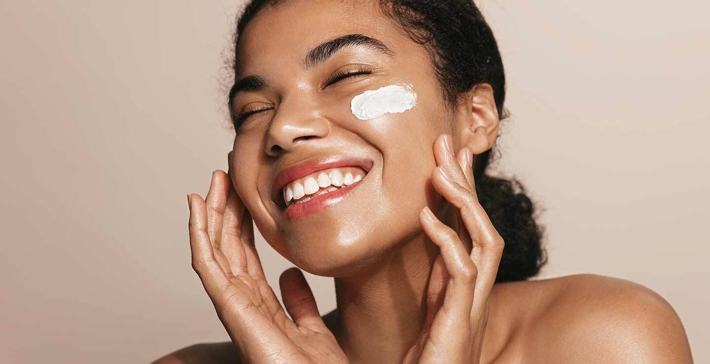 A woman gently caressing her face.