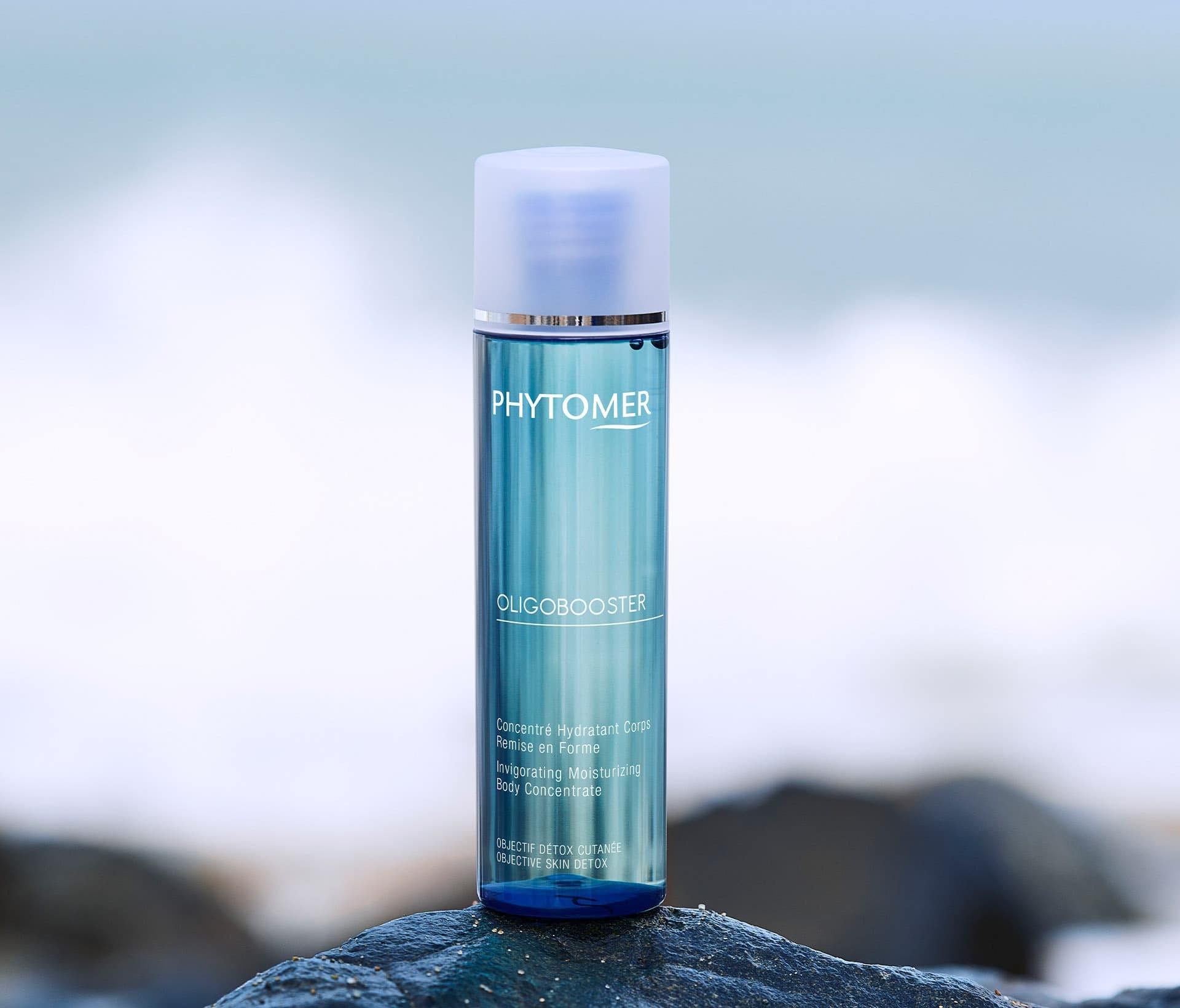 Oligobooster Invigorating Moisturizing Body Concentrate, 125 ml bottle at the beach