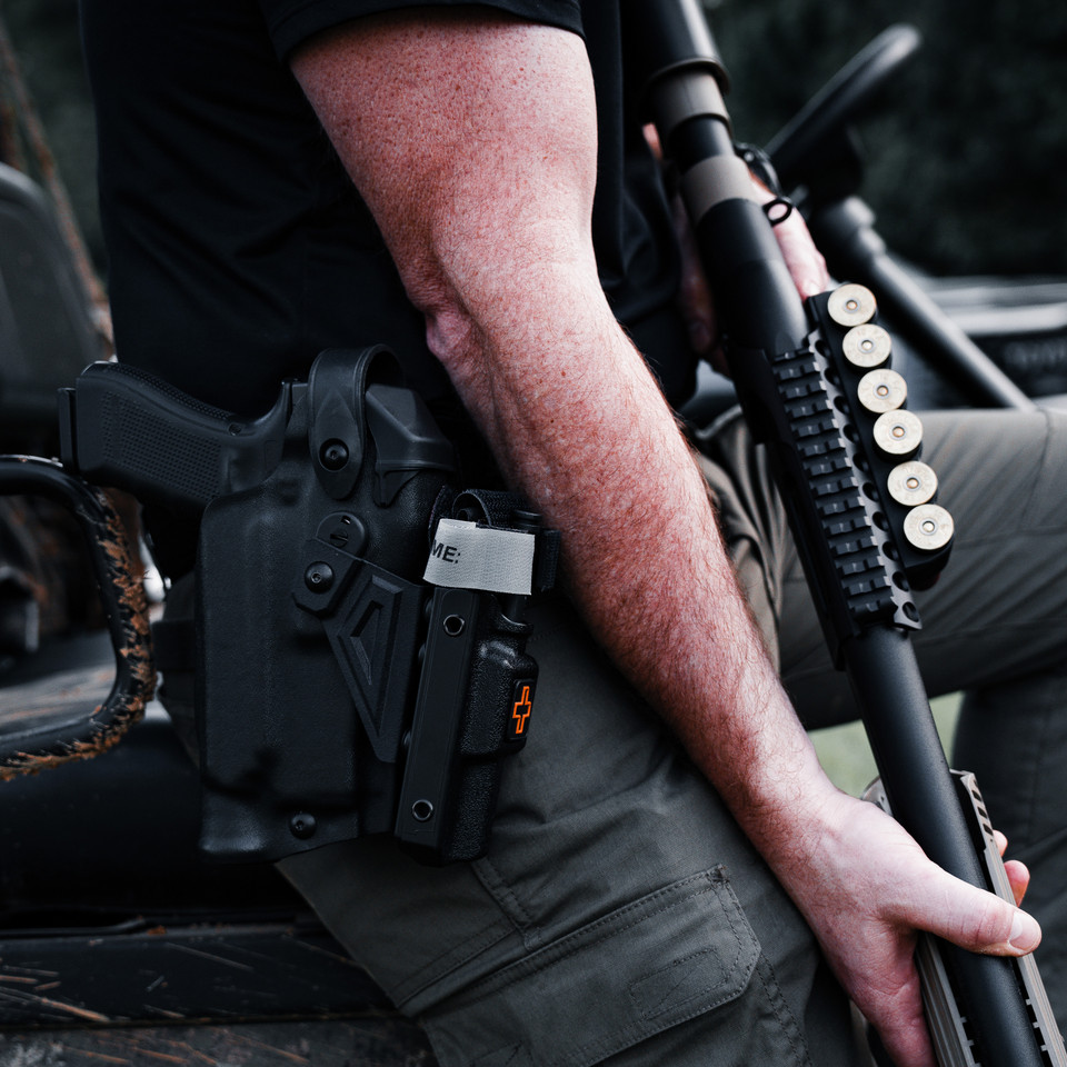 Pistol holster mount for tourniquet carrier.  Tourniquet mounting bracket for Safariland SLS / ALS holsters.  Red dot and non-red dot sight models. Eleven 10 RIGID TQ Case Holster Mount.
