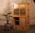 Reproduction Japanese tea chest with sliding glass and wood doors, lower drawers, and a two-section layout that combines functional storage with elegant design.