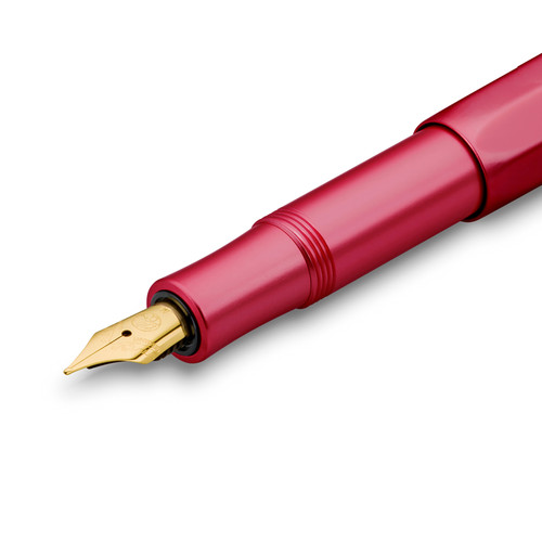 An uncapped ruby red fountain pen with a gold nib.