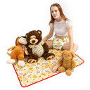 Female model sitting on the Safari change pad with stuffed animals.