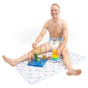 Male model sitting on change pad with toys.