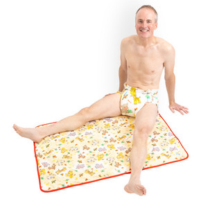 Male model sitting on the absorbent Safari change pad.