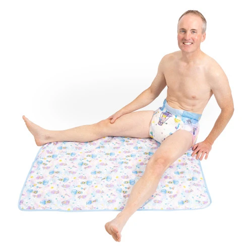 Male model sitting on absorbent change pad.