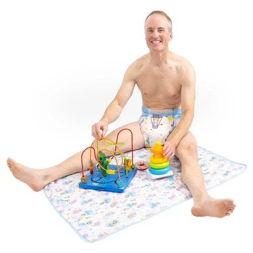 Male model sitting on change pad with toys.