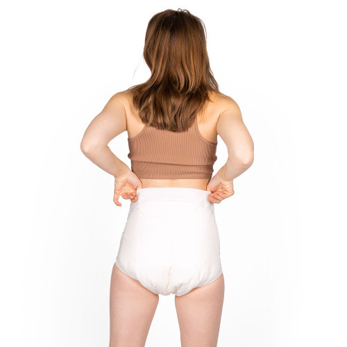 Female model wearing EliteCare Premium Briefs, back-view.