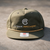 Olive Cyber Archery 5-panel rope snapback hat, front view, embroidered logo and gold bill rope, Richardson sticker on visor.