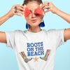 woman wearing Beach life boots top that reads "boots on the beach" and holding watermelon slices over eyes