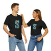 Couple looking at each other smiling wearing black matching couples monogram tees in ocean alphabet
