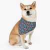 Dog sitting while wearing a colorful beach bandana