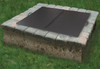 Square folding fire pit stainless steel snuffer lid on top of paver wood burning fire pit.