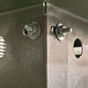 Up close view of the assembly of the fire pit insert with the bolts.