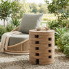 ZUO MODERN Zuo Mado Side Table Natural, round wooden side table with a modern, open slot design, placed outdoors next to a lounge chair.