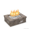 Rectangular paver fire pit with The Outdoor Plus stainless steel bullet burner kit lit, showing tall flames and a Match Lit key valve on the front wall