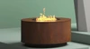 Cylinder Natural Gas Fire Table shown in the corten steel natural rust finish.