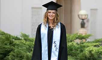 woman-graduation-cap-gown-blue-sorority-stole.jpg