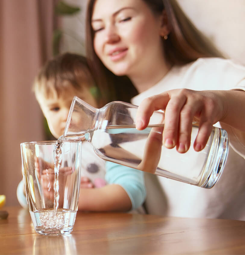 mother and child with glass of water