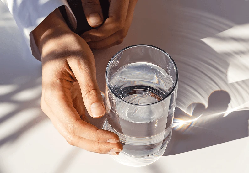sun shining on a glass of water