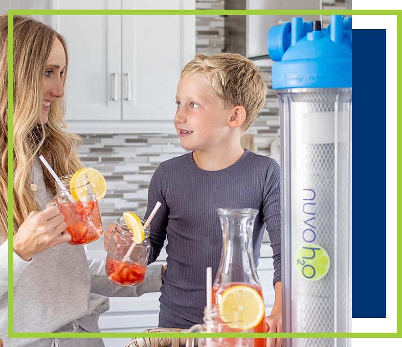 a family drinking strawberry water next to a nuvoh2o system
