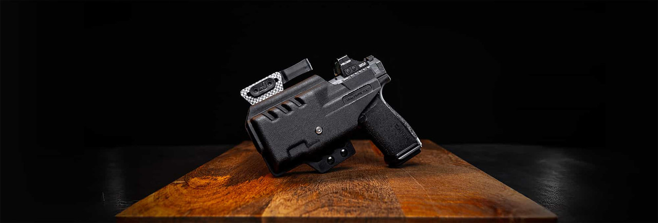 Canik Mete MC9 Prime pistol with a TLR7 Sub weapon light next to a Tulster ARC holster, showcasing a modern and versatile concealed carry setup.