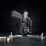 A Glock 19 with a Streamlight TLR-7  weapon light in a Tulster ARC light-bearing kydex holster on a table.