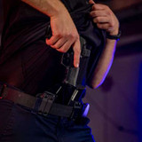 Person drawing a Sig Sauer P365 Fuse in a Tulster Profile+ holster being concealed carried inside-the-waistband (IWB) in the appendix position with an Echo Magazine Carrier.