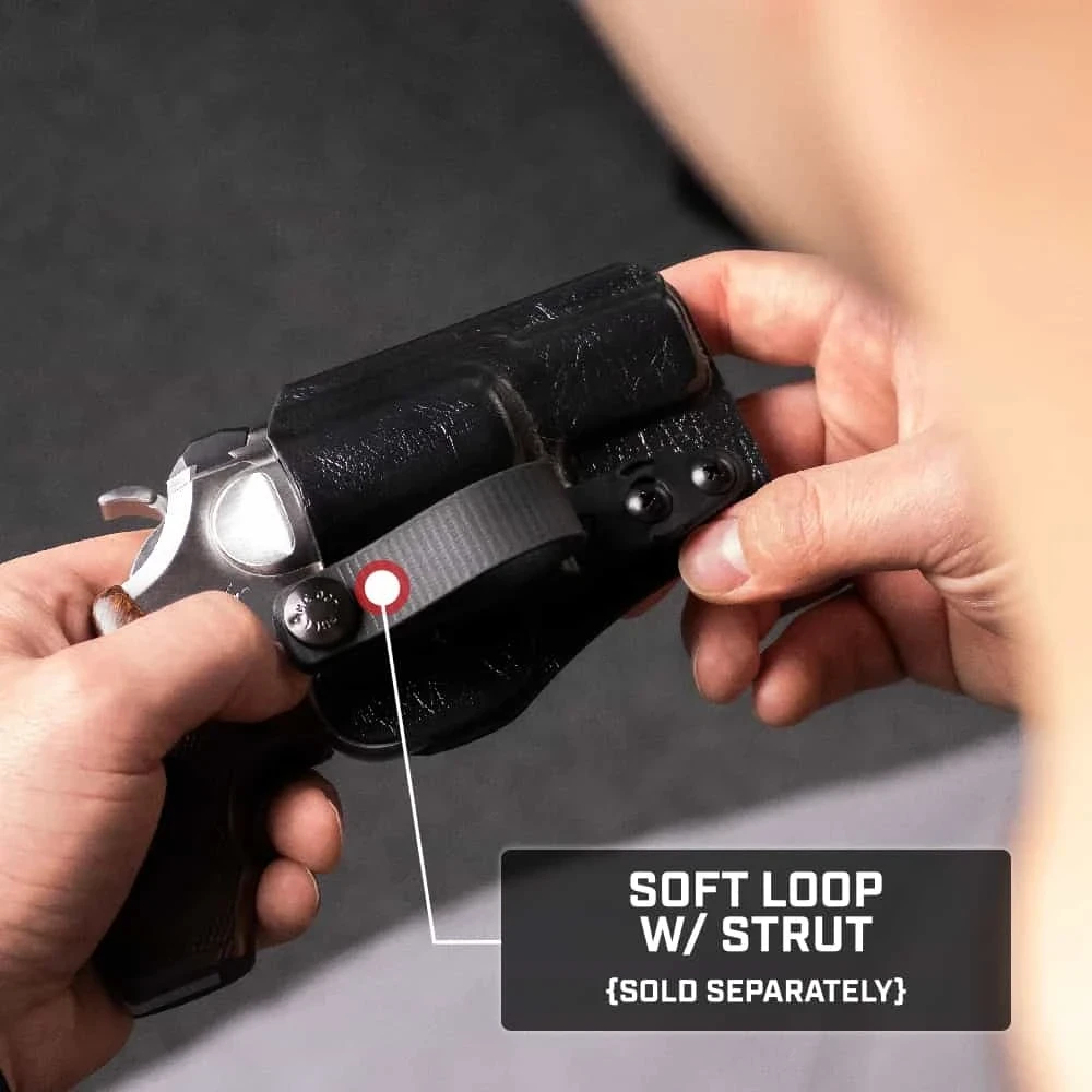 Hands holding a black Tulster RATH revolver holster with the Soft Loop with Strut attachment, sold separately.