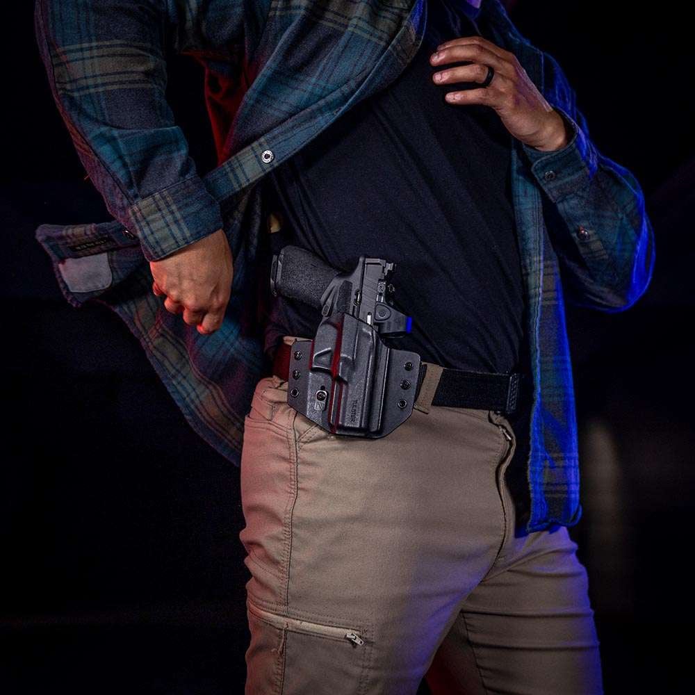 Man in a flannel shirt wearing a Tulster Contour OWB holster at the 3 o'clock strong-side position.