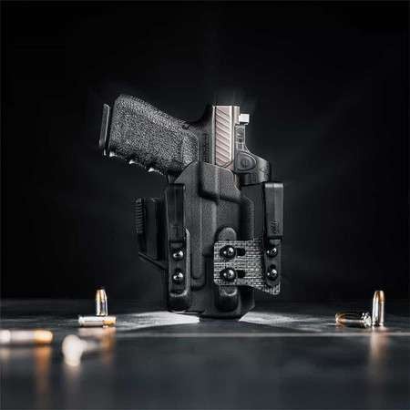 A Glock 19 with a Streamlight TLR-7  weapon light in a Tulster ARC light-bearing kydex holster on a table.