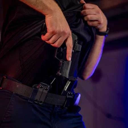 Person drawing a Sig Sauer P365 Fuse in a Tulster Profile+ holster being concealed carried inside-the-waistband (IWB) in the appendix position with an Echo Magazine Carrier.