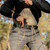 A person drawing a Sig Sauer pistol from an ARC inside the waistband light-bearing holster from Tulster.