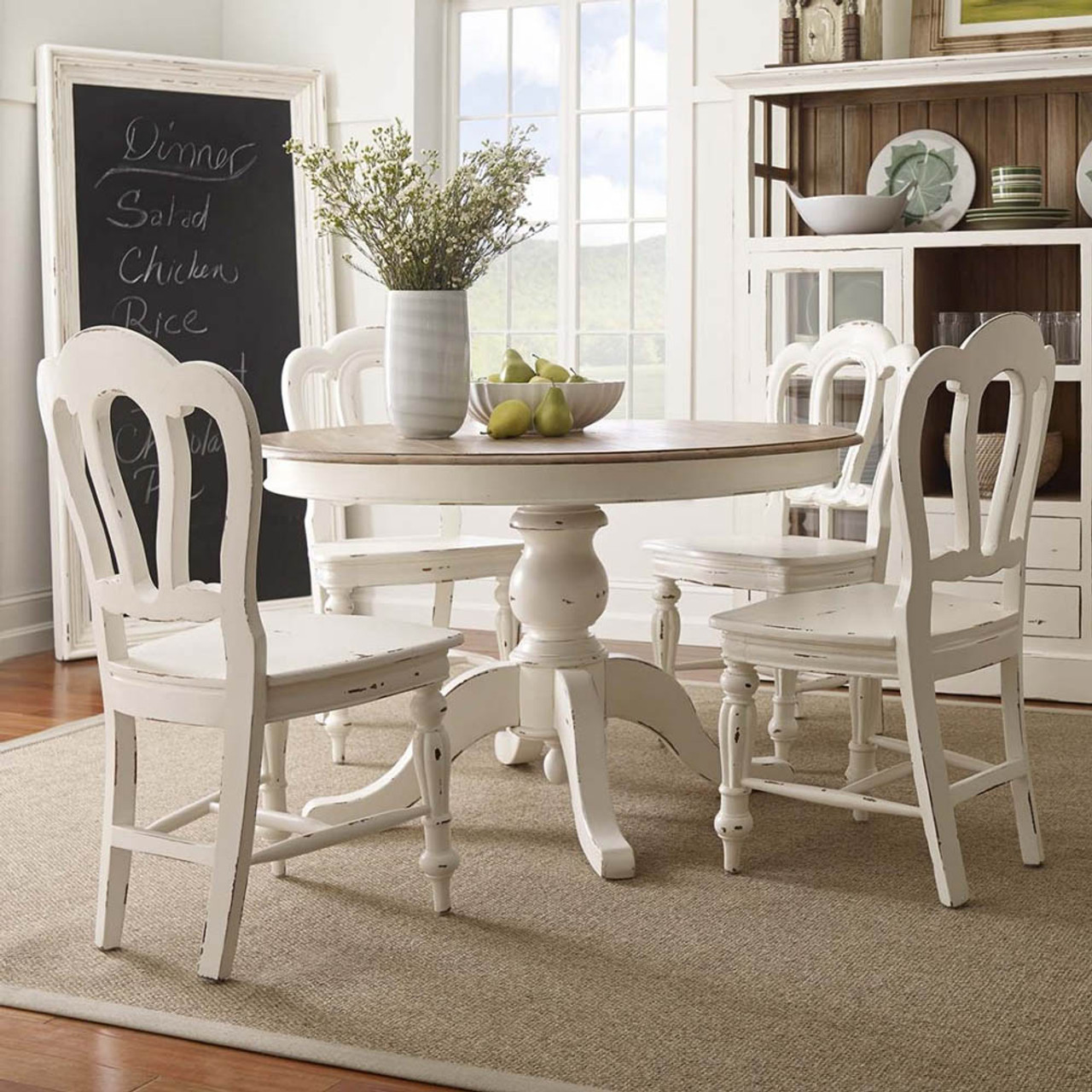 round dining table with white chairs