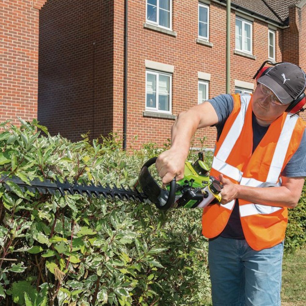 Man using Husqvarna style hedge trimmer by draper tools