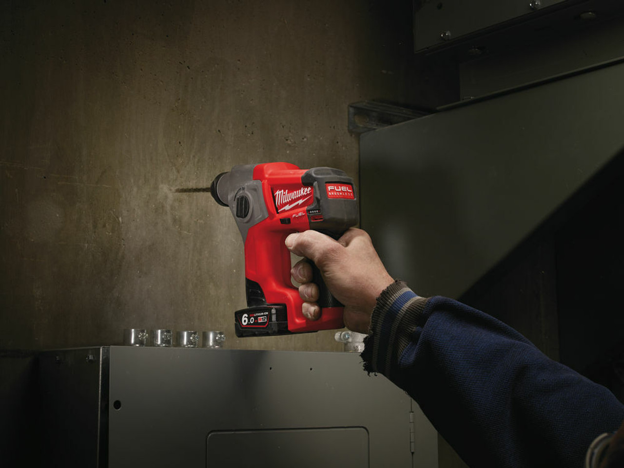 in use photography of milwaukee 12 volt sds hammer drill