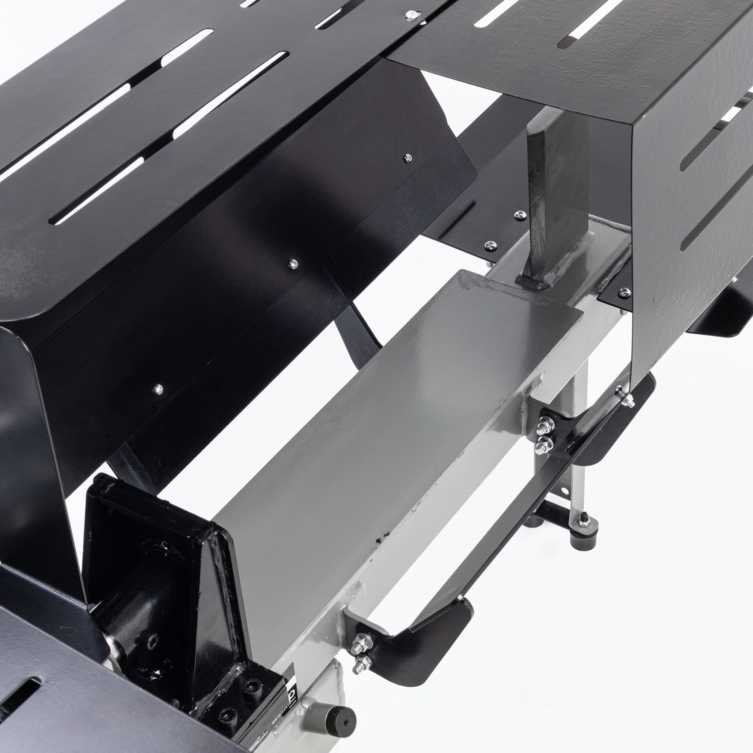 Protective steel guarding prevents accidental contact with the log splitting area.