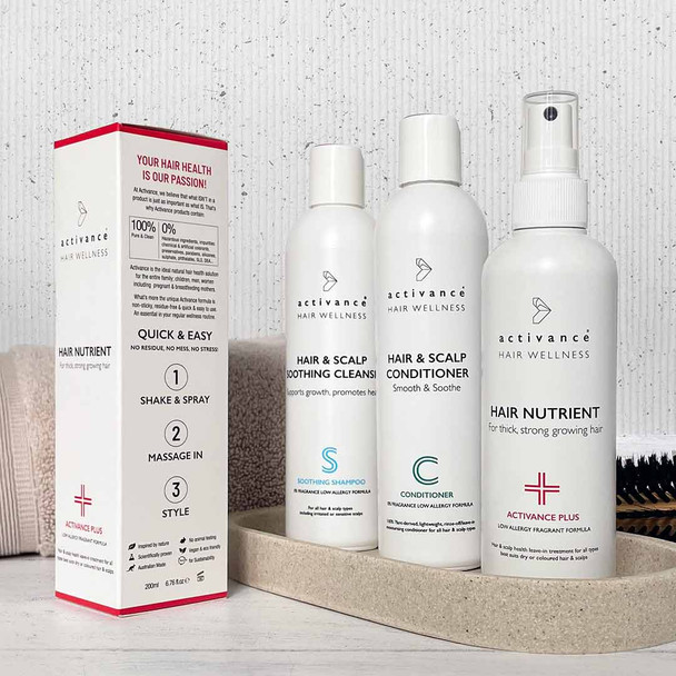 200ml bottle of Activance Plus with 250ml bottles of Soothing Shampoo and Nourishing Conditioner sitting on stone tray.