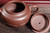 Detailed view of a fully handmade Yixing Zisha teapot with the lid removed, revealing the refined clay texture, smooth inner surface, and precise craftsmanship of traditional Yixing pottery.