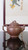 English: Full mirror reflection shot of Taobaochun Zisha Teapot by Senior Arts & Crafts Master, crafted from authentic Yixing raw purple clay. The whole pot adopts bionic peach branch design for spout, handle and lid, showing elegant full body silhouette.