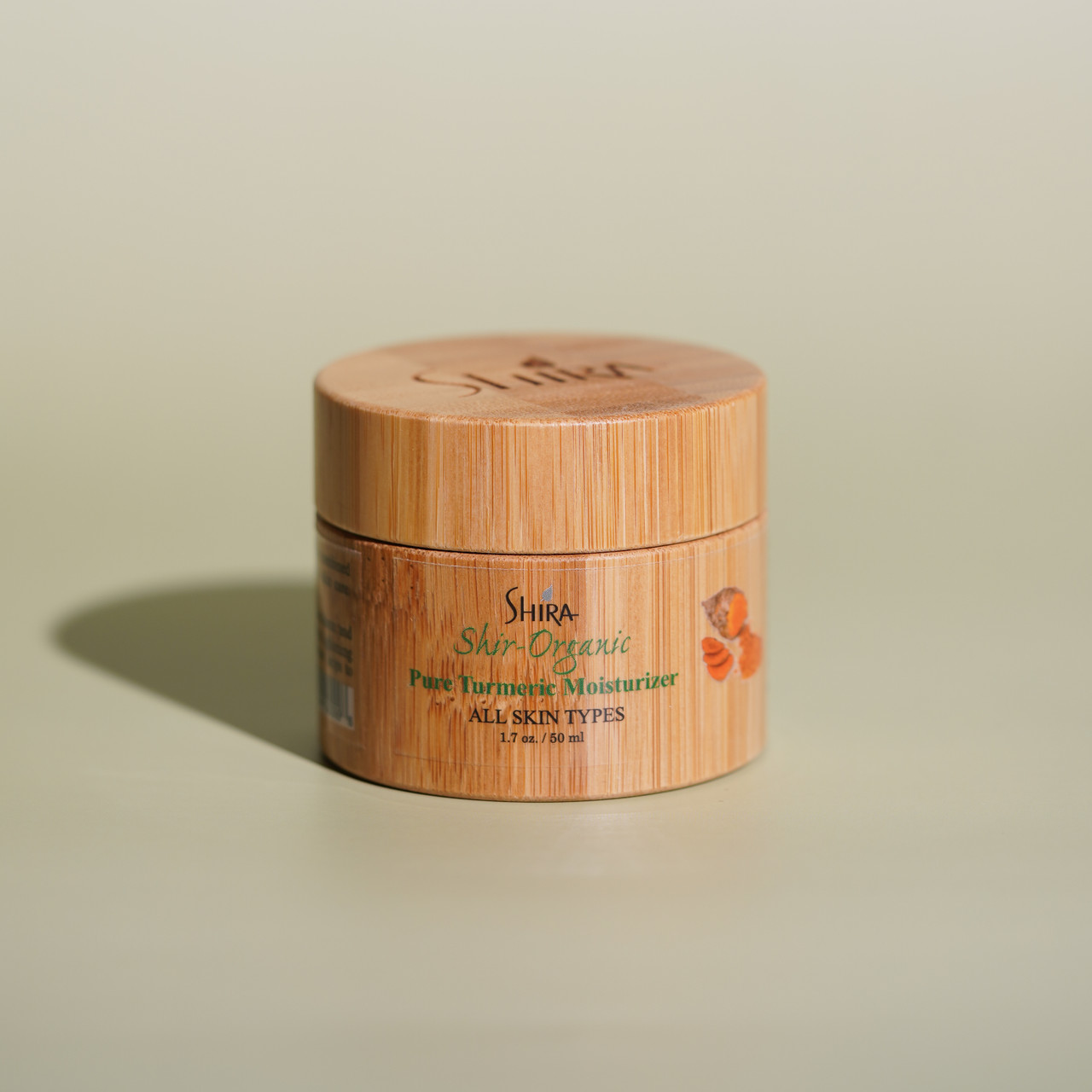 Pure Turmeric Moisturizer by Shira with green background