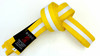 Shop Kids BJJ Yellow Belt with White Stripe – durable, 4cm wide martial arts belt with black tab. Perfect for young Brazilian Jiu-Jitsu practitioners. Sizes 0–3.
