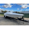 White marine shrink wrap covering a boat on a trailer for outdoor storage and weather protection