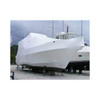 Large powerboat protected with white marine shrink wrap at a boat storage yard