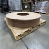 Angled view of stacked Kraft vapor barrier donuts with 50" outer diameter and 20" inner diameter