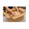 Worker placing a kraft paper wrapped product into a shipping box with paper void fill