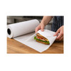 Person wrapping a sandwich with white butcher paper on a food preparation counter