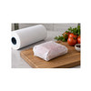 Food securely wrapped in white freezer paper beside a freezer paper roll on a cutting board