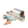 Polyolefin shrink film roll on tabletop dispenser wrapping a retail product package